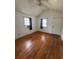 Well-lit bedroom with hardwood floors, ceiling fan, and a bright window at 4622 Dogwood Rd, Pine Lake, GA 30072