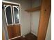 View of a closet with shelf and a hinged door with glass inserts at 4622 Dogwood Rd, Pine Lake, GA 30072