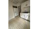 Kitchen includes white appliances, tile floor, and ample cabinet space at 4622 Dogwood Rd, Pine Lake, GA 30072