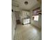 Modest kitchen features white cabinets, tile flooring and a window at 4622 Dogwood Rd, Pine Lake, GA 30072
