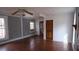 Living room features original wood floors, ample windows, and freshly painted walls at 4622 Dogwood Rd, Pine Lake, GA 30072