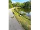 Picturesque scene of a pond with geese and goslings near a paved path and verdant trees at 4622 Dogwood Rd, Pine Lake, GA 30072