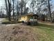 Single-story house with a covered porch in a wooded lot at 4622 Dogwood Rd, Pine Lake, GA 30072