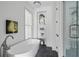 Bathroom featuring soaking tub, shower with glass door, and decorative shelving at 100 Sheridan Dr, Atlanta, GA 30305