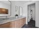 Bathroom featuring double vanity with marble countertop, modern fixtures, and soaking tub in adjacent room at 100 Sheridan Dr, Atlanta, GA 30305