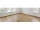 Bedroom with hardwood flooring, bright neutral walls, and natural lighting through surrounding windows at 100 Sheridan Dr, Atlanta, GA 30305