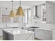 Bright, modern kitchen with gray cabinetry, white countertops, stainless steel appliances, and stylish pendant lighting at 100 Sheridan Dr, Atlanta, GA 30305