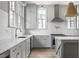 Well-lit kitchen featuring gray cabinets, a white tile backsplash, stainless steel appliances, and marble countertops at 100 Sheridan Dr, Atlanta, GA 30305
