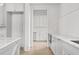 Contemporary kitchen with white cabinets, marble countertops, and stainless steel appliances leading to pantry at 100 Sheridan Dr, Atlanta, GA 30305