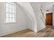 Cozy landing area featuring hardwood floors, staircase, window and wooden door at 100 Sheridan Dr, Atlanta, GA 30305