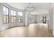 Bright, open living room featuring hardwood floors, large windows, and arched doorways for seamless flow at 100 Sheridan Dr, Atlanta, GA 30305