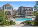 Upscale community pool with lounge chairs and umbrellas situated near brick and white trim buildings at 100 Sheridan Dr, Atlanta, GA 30305