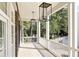 Inviting outdoor porch with wooden floors and white railing, featuring elegant lighting fixtures and peaceful views at 100 Sheridan Dr, Atlanta, GA 30305