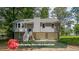 Two story home featuring a two car garage, landscaping allowance and front porch with stairs at 180 Old Airport Rd, Carrollton, GA 30116