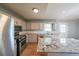 Spacious kitchen featuring stainless steel appliances, granite counters and a tile floor at 180 Old Airport Rd, Carrollton, GA 30116