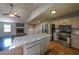 Modern kitchen features stainless steel appliances, an island with marble counters and tile floors at 180 Old Airport Rd, Carrollton, GA 30116