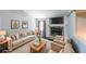 Bright living room with a stone fireplace, large sofa, two armchairs and a wood coffee table at 180 Old Airport Rd, Carrollton, GA 30116
