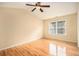 Bright bedroom features hardwood floors, a ceiling fan, and a window with natural light at 3364 Thornbridge Dr # 0, Powder Springs, GA 30127