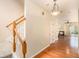 Inviting hallway with hardwood floors, staircase, and view into a cozy living room with a fireplace at 3364 Thornbridge Dr # 0, Powder Springs, GA 30127