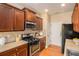 Functional kitchen with stainless steel appliances, dark wood cabinetry, and tiled backsplash at 3364 Thornbridge Dr # 0, Powder Springs, GA 30127