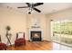 Inviting living room featuring a cozy fireplace and sliding glass doors to the backyard at 3364 Thornbridge Dr # 0, Powder Springs, GA 30127