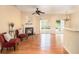 Cozy living room with hardwood floors, fireplace, ceiling fan, and sliding glass doors to the patio at 3364 Thornbridge Dr # 0, Powder Springs, GA 30127