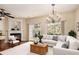 Spacious living room featuring a fireplace, hardwood floors, a ceiling fan, and sliding glass doors at 3364 Thornbridge Dr # 0, Powder Springs, GA 30127
