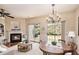 Inviting living room featuring a fireplace, hardwood floors, a chandelier, and sliding glass doors at 3364 Thornbridge Dr # 0, Powder Springs, GA 30127
