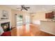 Open concept living room with fireplace, hardwood floors, ceiling fan, and access to the outdoor area at 3364 Thornbridge Dr # 0, Powder Springs, GA 30127