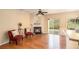 Bright living room featuring hardwood floors, a fireplace, ceiling fan, and sliding glass doors to the backyard at 3364 Thornbridge Dr # 0, Powder Springs, GA 30127