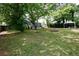 Expansive backyard featuring a covered patio, fire pit, and lush green lawn, perfect for outdoor entertaining at 139 Merritt Se St, Marietta, GA 30060