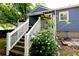 Exterior view of the rear of the home with access steps and lush landscaping at 139 Merritt Se St, Marietta, GA 30060