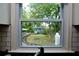 Kitchen window view of the backyard, featuring a shed and lush greenery at 139 Merritt Se St, Marietta, GA 30060