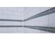 Close-up of a bright, white subway tile shower with decorative glass accent tiles at 139 Merritt Se St, Marietta, GA 30060