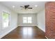 Bright bedroom features beautiful hardwood floors, large windows, and a decorative brick accent wall at 139 Merritt Se St, Marietta, GA 30060