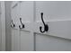 Close-up of stylish coat hooks mounted on a white board and batten wall in the entryway at 139 Merritt Se St, Marietta, GA 30060
