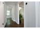 Hallway featuring hardwood floors and neutral paint tones, showing access to multiple rooms at 139 Merritt Se St, Marietta, GA 30060