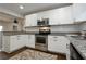 Bright kitchen with white cabinets, granite countertops, and stainless steel appliances at 139 Merritt Se St, Marietta, GA 30060