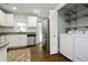 The kitchen and laundry area featuring modern appliances and white cabinetry at 139 Merritt Se St, Marietta, GA 30060