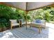 Comfortable outdoor seating arrangement with a wooden table and plush cushions at 139 Merritt Se St, Marietta, GA 30060