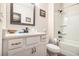 Bright bathroom with white vanity, gold hardware, framed mirror, and shower/tub combo at 30 Deer Creek Ct, Moreland, GA 30259