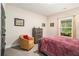 Inviting bedroom with a large bed, side chair, neutral walls, and view to outside at 30 Deer Creek Ct, Moreland, GA 30259