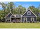 Charming craftsman home with a manicured lawn and lush landscaping, set against a picturesque blue sky at 30 Deer Creek Ct, Moreland, GA 30259