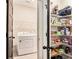 Well-organized laundry room with shelving, a washer, dryer, and ample storage space, making chores a breeze at 30 Deer Creek Ct, Moreland, GA 30259
