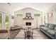 Cozy living room featuring a brick fireplace, ample natural light, and comfortable seating, perfect for relaxation at 30 Deer Creek Ct, Moreland, GA 30259