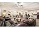 Spacious open-concept living room featuring a fireplace, modern ceiling fan, and seamlessly connects to kitchen and dining areas at 30 Deer Creek Ct, Moreland, GA 30259