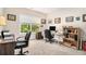 Spacious office featuring two desks, comfortable chairs, and a window with a green, wooded view at 30 Deer Creek Ct, Moreland, GA 30259