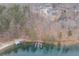 Aerial view of neighborhood homes on a lake showcasing a private dock and boat lift at 7625 Breeze Bay Rd, Cumming, GA 30041