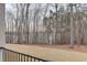 Large backyard view from the deck of the home, featuring a lake in the background at 7625 Breeze Bay Rd, Cumming, GA 30041