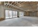 Unfinished basement with sliding doors leading to a serene outdoor view at 7625 Breeze Bay Rd, Cumming, GA 30041
